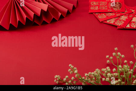 The red background of Chinese New Year's theme, with red folding fan and lucky money, Floret, translation：may prosperity be with you Stock Photo