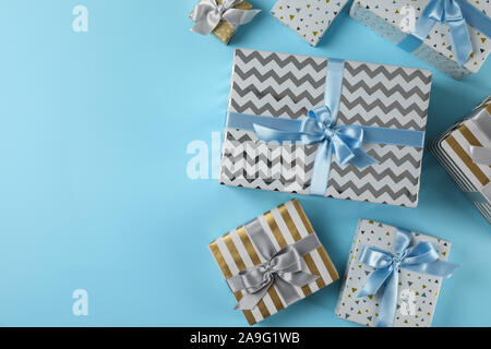 Different gift boxes on blue background, copy space Stock Photo