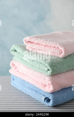 Stack of clean towels on ironing board, copy space Stock Photo