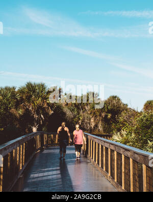Healthy active women walk the boardwalk at New Smyrna Dunes Park in New Smyrna Beach, Florida Stock Photo