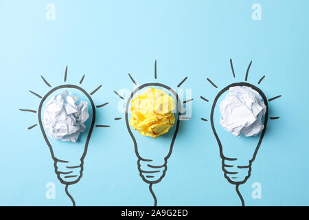 Drawn light bulbs and paper balls on blue background, space for text Stock Photo