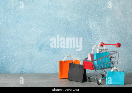 Download Small Shopping Cart With Paper Bags On Yellow Background Space For Text Stock Photo Alamy PSD Mockup Templates