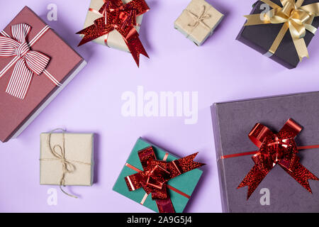 Holiday composition. Various handmade gift boxes on pastel violet background. Birthday concept. Flat lay, top view, copy space Stock Photo