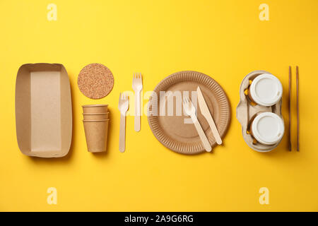 Flat lay with eco - friendly tableware on yellow background, space for text Stock Photo