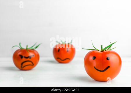 different emotions on tomatoes. Joy. Anger Sadness Despair Stock Photo