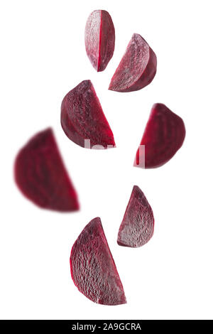 Flying set peeled pieces of beetroot on white background. Healthy raw vegetable. Isolated. Close up. Vertical orientation. Stock Photo
