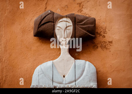 A carved wooden model of a woman  used as an advert for a gite holiday accommodation in Eguisheim Alsace France Europe Stock Photo