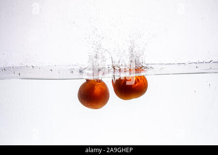 fruit in a spray of water isolated on a white background. Stock Photo