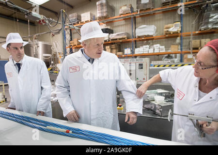 Prime Minister Boris Johnson is shown how to make rock during a visit to Coronation Candy in Blackpool while General Election campaigning. PA Photo. Picture date: Friday November 15, 2019. See PA story POLITICS Election. Photo credit should read: Stefan Rousseau/PA Wire