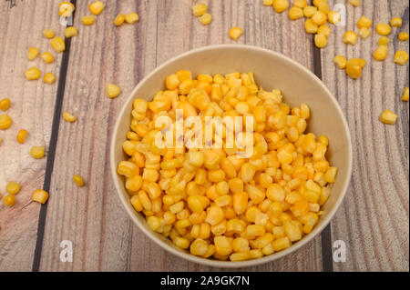 Grains of sweet corn in a plate on the table. Healthy diet. Fitness diet. For a sweet treat. Close up Stock Photo