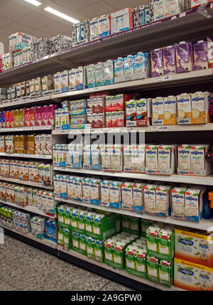 London, UK - November 12th 2019: A variety of vegan milks in a supermarket. Wide selection of plant based beverages of different brands. Stock Photo