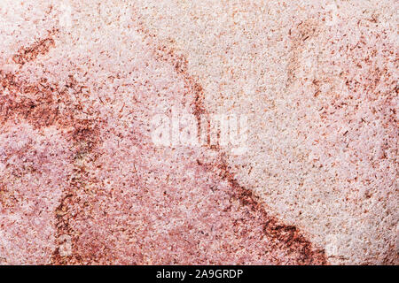 Macro texture of smooth sea pebbles. Stone background in red shades Stock Photo