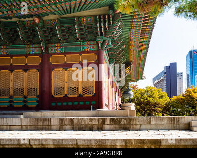 SEOUL, SOUTH KOREA - OCTOBER 30, 2019: building of Deoksugung (Deoksu Palace) and modern houses in Seoul. This complex is one of the Five Grand Palace
