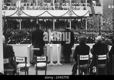 Rear View of U.S. President Dwight Eisenhower and U.S. Vice President Richard Nixon Reviewing Inauguration Parade, First Lady Mamie Eisenhower and Second Lady Pat Nixon seated right, Washington, D.C., USA, photographer Thomas J. O'Halloran, Warren K. Leffler, January 21, 1957 Stock Photo