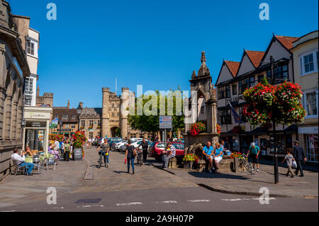 The towers of Wells Cathedral from the market place with the well in the foreground Stock Photo