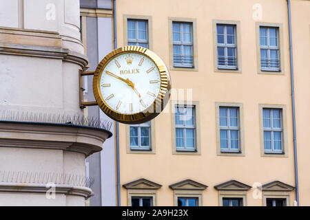 DRESDEN, GERMANY - APRIL 1 2018: Rolex Swiss luxury watch company logo on golden wall clock over the shop on April 1, 2018 in Dresden, Germany. Stock Photo