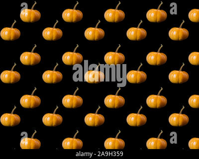 Seamless pattern from a photo of pumpkins on a black background. Stock Photo