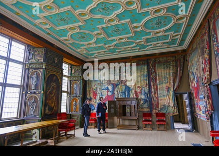 Two people listening to a guided commentary on head-phones inside Star Chamber at The Little Castle at Bolsover Castle, Derbyshire, England, UK Stock Photo