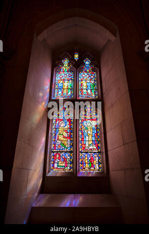 WASHINGTON, DC - Stained glass window at the Way of Peace Entrance at Washington National Cathedral. Washington National Cathedral is an Episcopal church located in Washington DC and is the site of many of Washington DC's prominent church and remembrance services. Designed in the Neo-Gothic style, its construction was begun in 1906, with work continuing over following decades. It is the second-largest church building in the United States and stands as the fourth-tallest structure in Washington DC, a feature emphasized by sitting on a high point overlooking over the city. It is best known as Wa Stock Photo