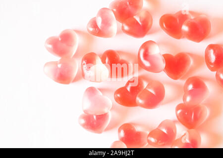 Pink heart shaped gummies background. Stock Photo
