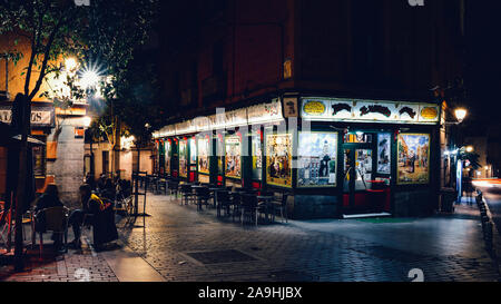 Madrid, Spain - Nov 16, 2019: Tapas bar in Madrid, Spain with traditional tiles. People sitting at terrace enjoying an evening Stock Photo