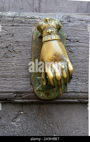 Hand shaped brass door knocker, Gorbio, France Stock Photo