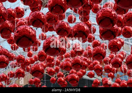 Red baubles hanging to decorate for Christmas holiday. Stock Photo