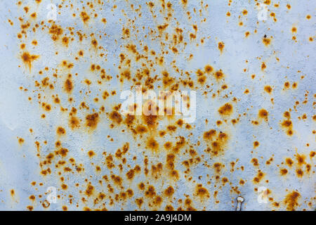 Light blue corroded metal background. Rusty and scratched painted metal wall. Rusty metal background with paint residue Stock Photo