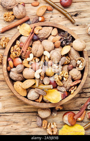 Nuts mix in a wooden plate.Different types of nuts. Stock Photo