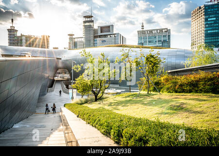 Seoul Korea , 23 September 2019 : Dongdaemun Design Plaza or DDP building view at sunset with green park in Seoul South Korea Stock Photo