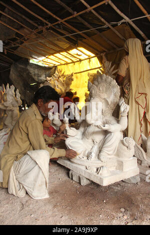 Man doing colour finish of God Ganesha statue, Pune, Maharashtra, India. Stock Photo