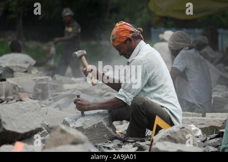 Man working on stone finishing for sculpture, Aurangabad, Maharashtra, India. Stock Photo