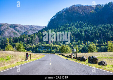 The Stunning scenic road abutting to the horizon in the protected national park area of the Columbia River Gorge along the riverbank with ridge of roc Stock Photo