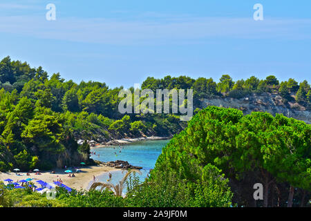 A scenic view across two beautiful small coves on the Kefalonia coastline near Lassi, with turquoise water and sandy beaches, backed with trees. Stock Photo