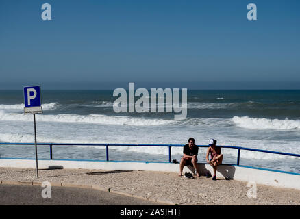 People relaxing by Praia das Maçãs, Big Beach Sintra, Portugal Stock Photo