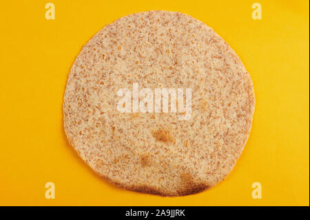 One tortilla for taco above top view isolated on yellow background Stock Photo