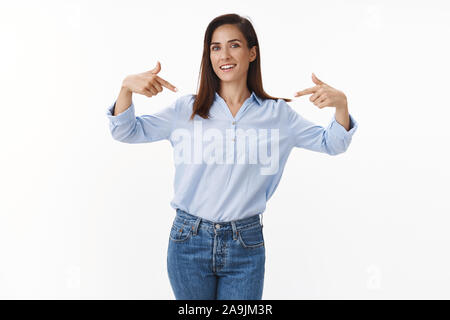 Determined professional wife entrepreneur boasting accomplishment, pointing proudly herself, talking personal win achievement, smiling happy, receive Stock Photo