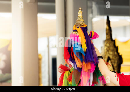The traditional colorful fabrics tied in the Thai Buddhist Temple for praying, colorful fabric according to faith Stock Photo