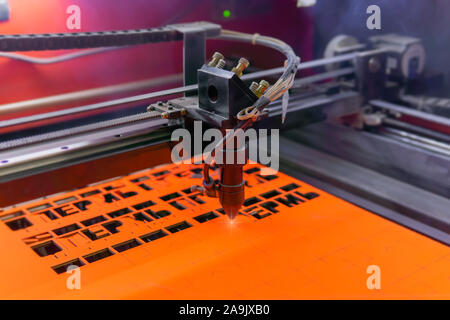 Perm, Russia - November 14, 2019: manufacturing plywood souvenirs on an automatic laser cutting machine Stock Photo