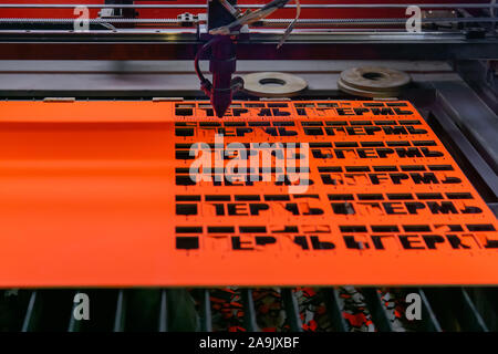 Perm, Russia - November 14, 2019: manufacturing plywood souvenirs on an automatic laser cutting machine Stock Photo