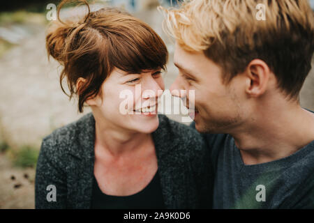 young heterosexual couple in love looking at each other Stock Photo