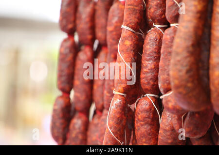 Close up of Chorizo sausages hanging up with string, speciality cuisine food from Spain. Stock Photo