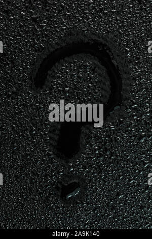 water drops on flat black rubber surface with the handwritten inscription - question mark Stock Photo