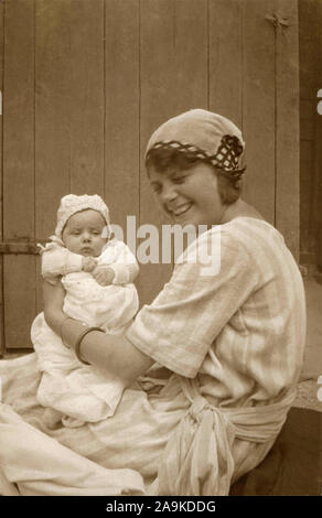 Woman with child in her arms, Denmark Stock Photo