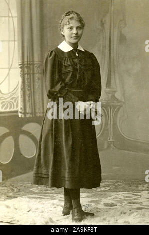 Portrait of a young woman dressed in black and white collar, Italy Stock Photo