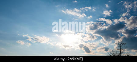 Beautiful blue sky with white clouds and sun, sunlight background abstract Stock Photo