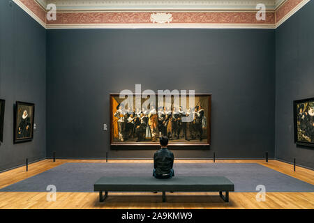 Amsterdam, Netherlands - July 20, 2019: Art lover admire the painting in Rijksmuseum Stock Photo