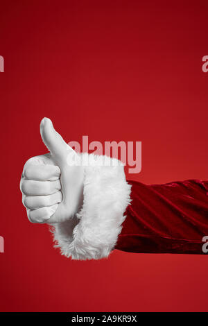 Close-up of man in white glove showing thumb up isolated on red background Stock Photo