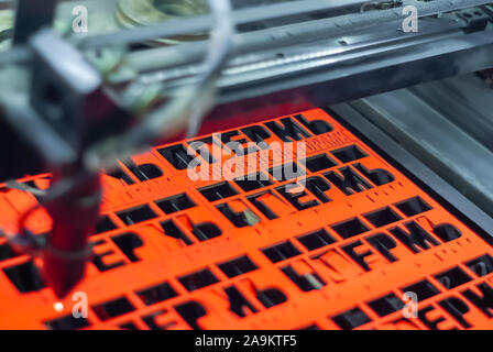 Perm, Russia - November 14, 2019: manufacturing plywood souvenirs on an automatic laser cutting machine Stock Photo