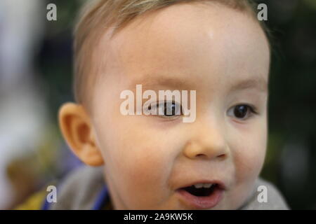 Child face christmas mood. Enthusiastic child. Good New Year spirit. Boy's face close up. Positive emotions. christmas mood. Stock Photo